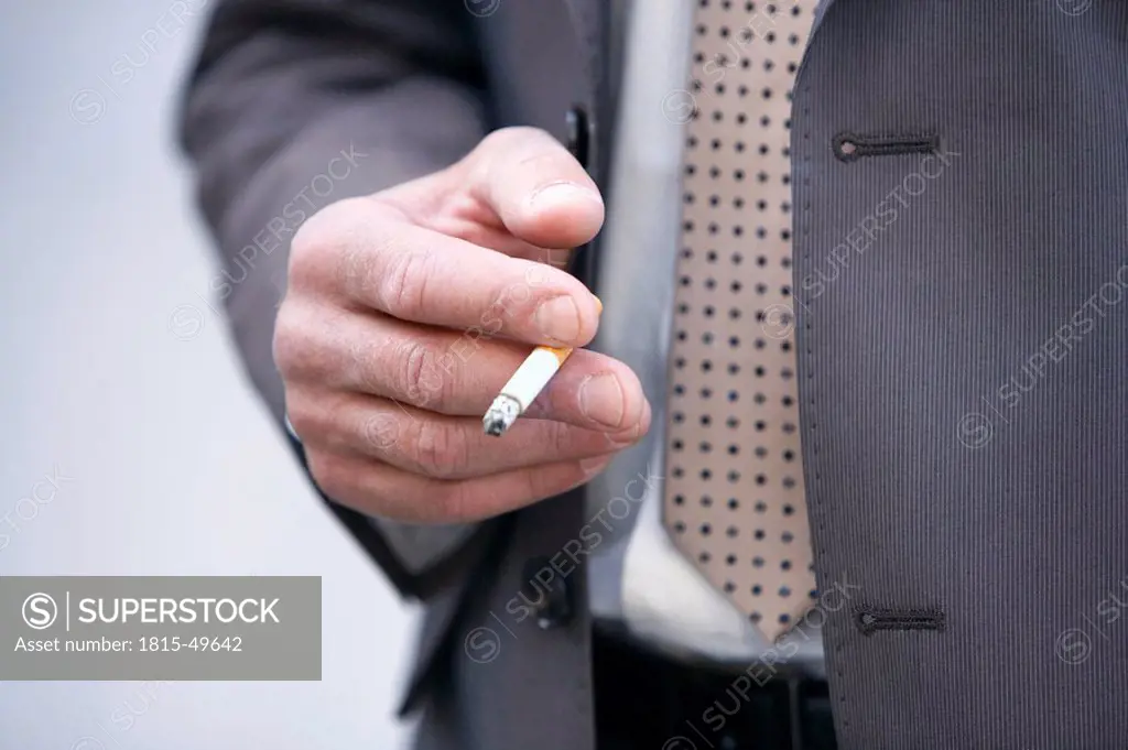 Germany, Baden_Württemberg, Stuttgart, Male person holding a cigarette, close up