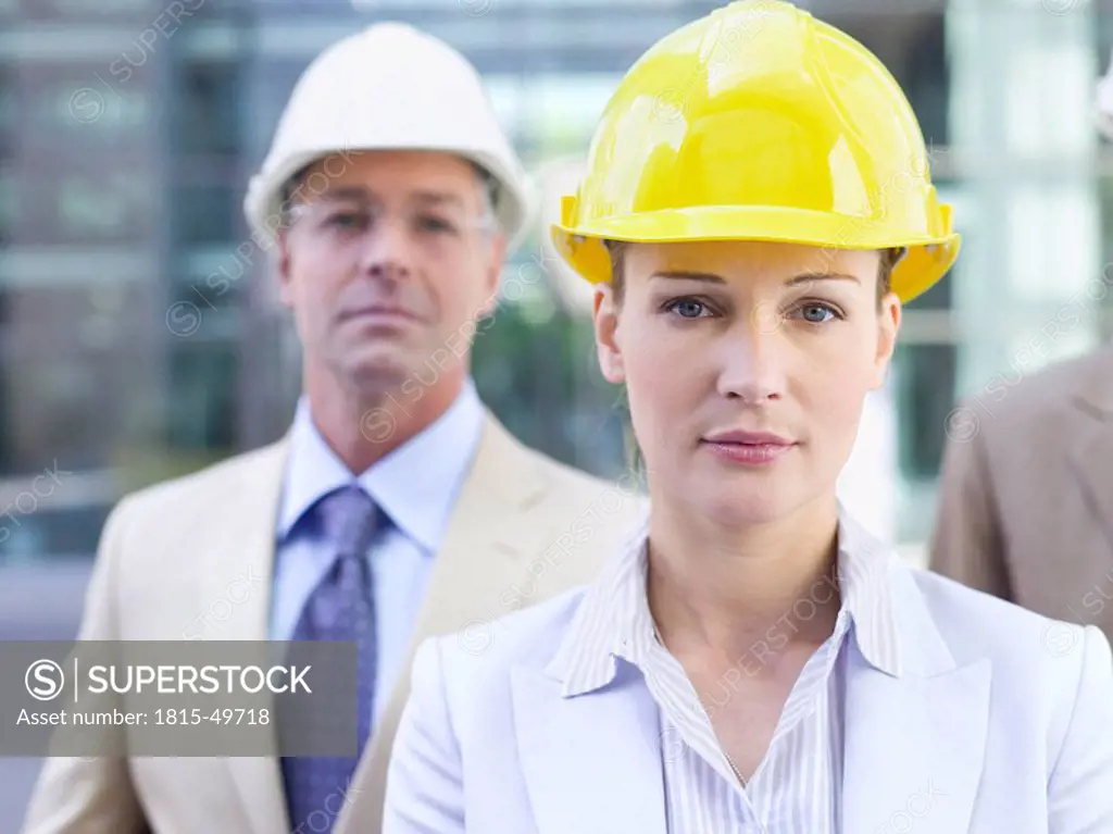 Germany, Baden_Württemberg, Stuttgart, Businesspeople wearing hard hats, portrait