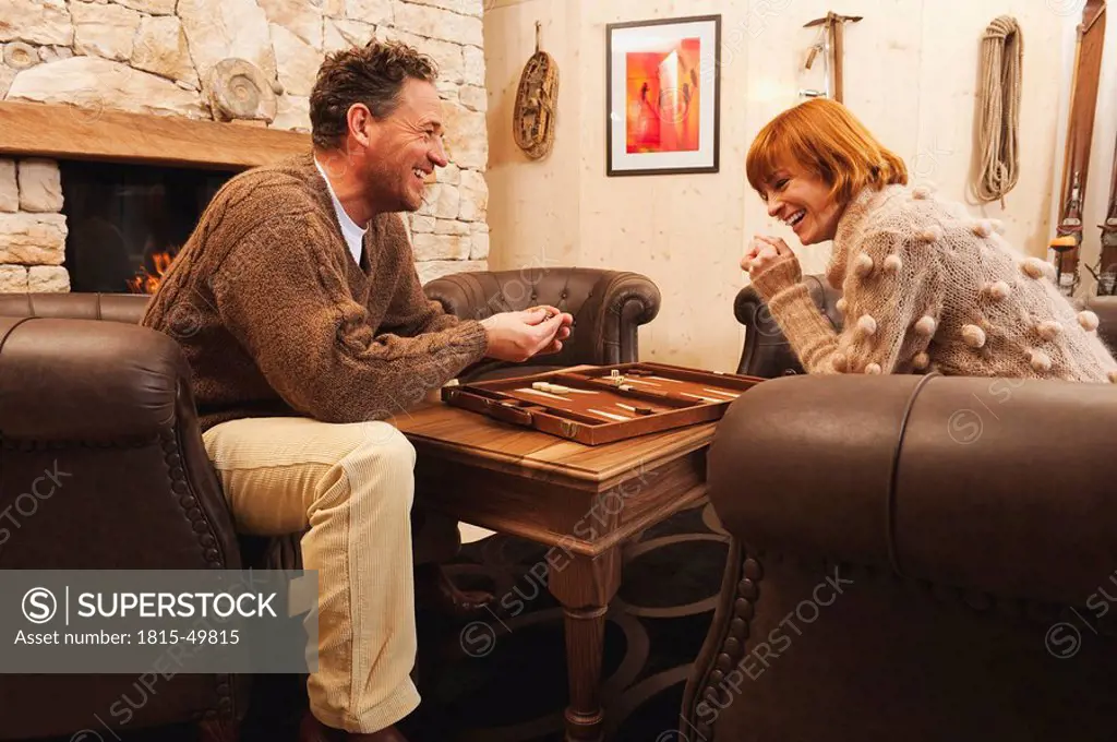 Couple playing backgammon, laughing