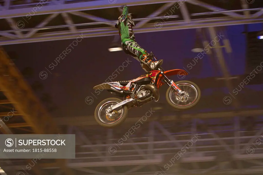 Germany, Munich, Olympia Hall, View of freestyle motocross rider performing stunts