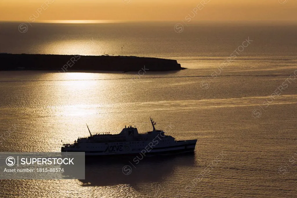 Europe, Greece, Thira, Cyclades, Santorini, Cruise liner in aegean sea at sunset