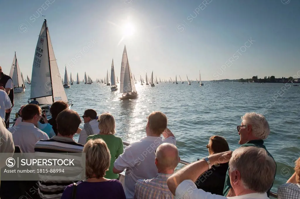 Germany, Lake Constance, People watching sailing boats