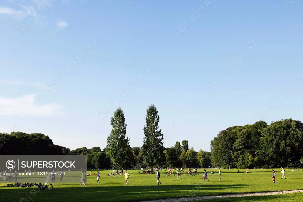 Germany, Bavaria, Upper Bavaria, Munich, People playing ball game in English Garden
