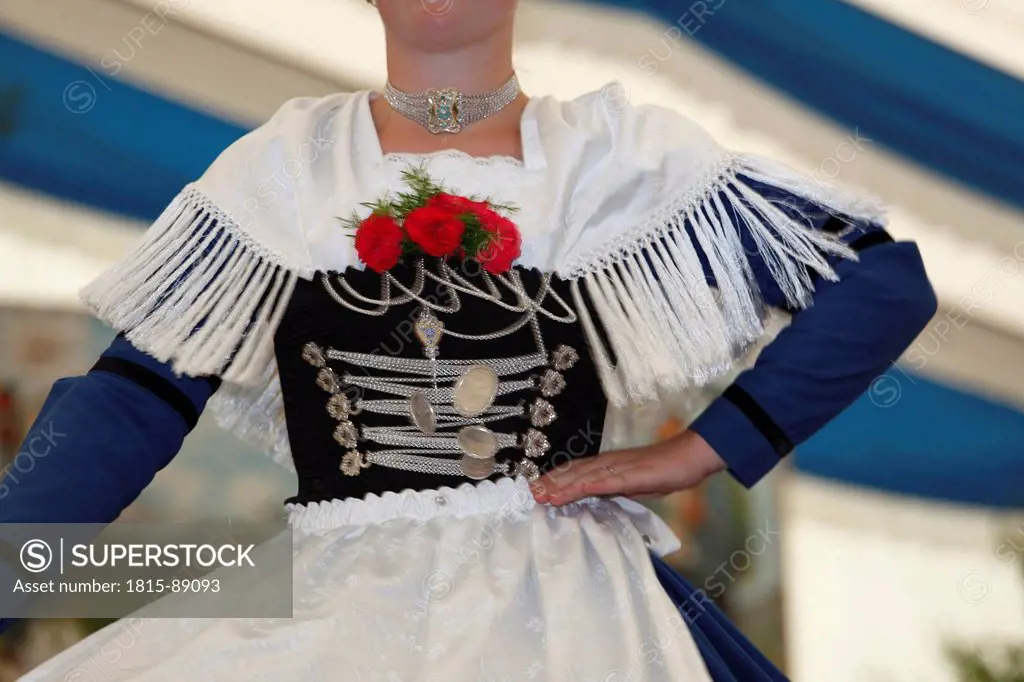 Germany, Bavaria, Upper Bavaria, Young woman performing traditional dance