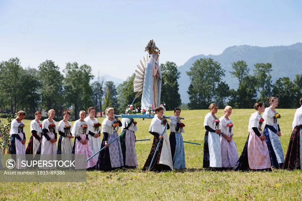 Germany, Bavaria, Upper Bavaria, Wackersberg, Women carrying decorated staue at feast of Corpus Christi procession