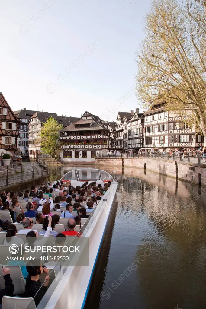 France, Alsace, Strasbourg, Petite_France, View of framed houses and tourboat in L´ill river