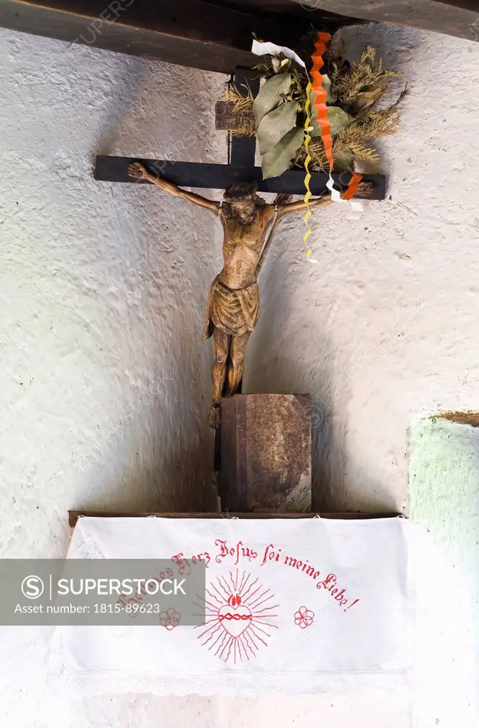Austria, Mondsee city, crucifix at farmhouse