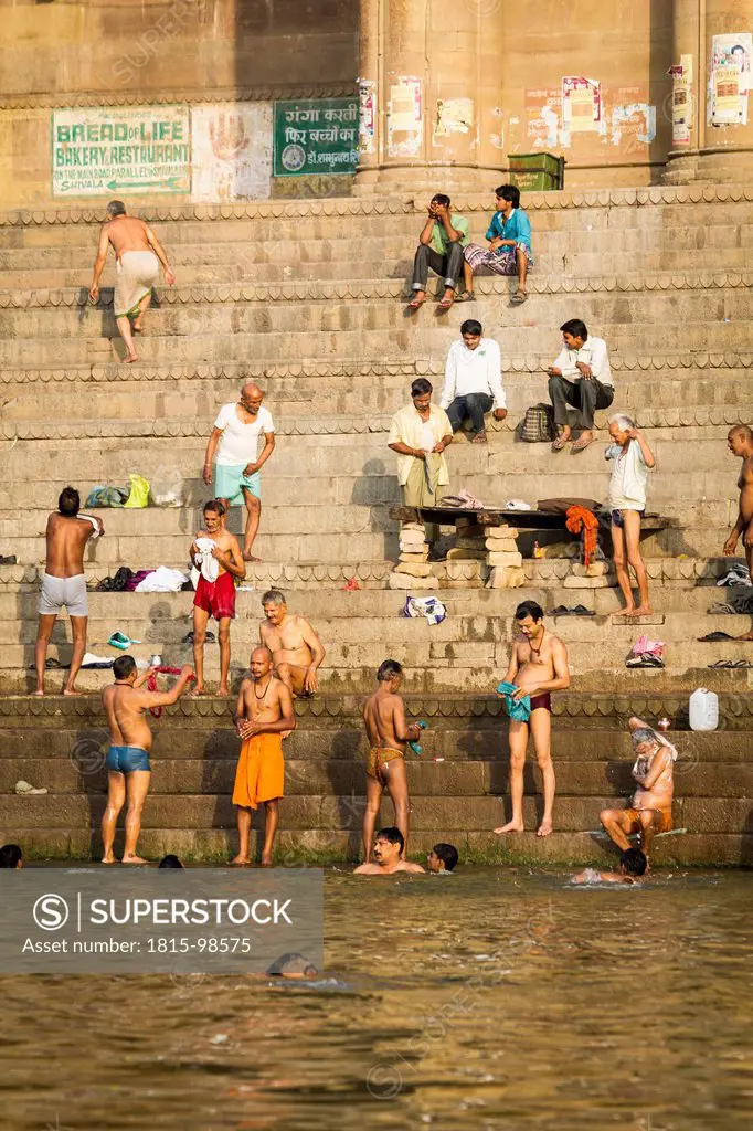 India, Uttar Pradesh, Varanasi, People taking morning bath and washing clothes at River Ganges