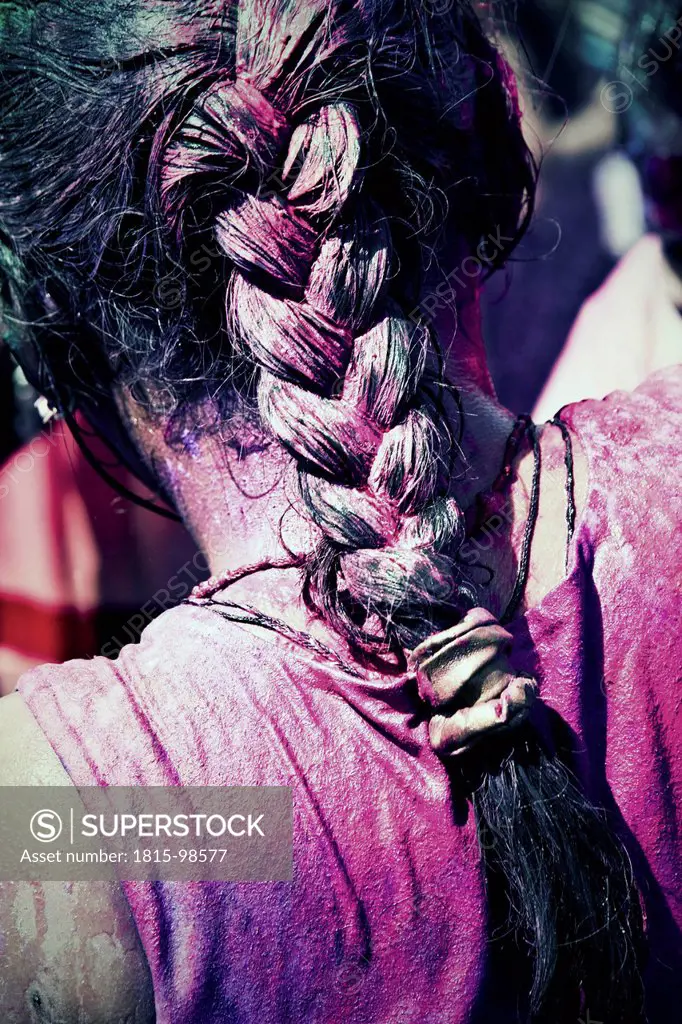 India, Ahmedabad, Coloured wet hair at Holi festival, close up