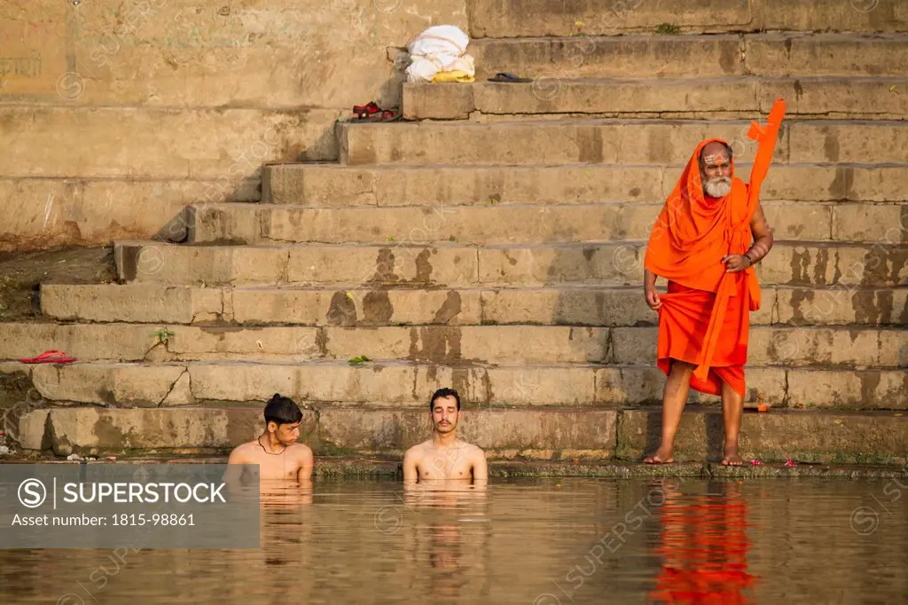 India, Uttar Pradesh, Varanasi, Men taking their morning bath and saying their pujas in Ganges river