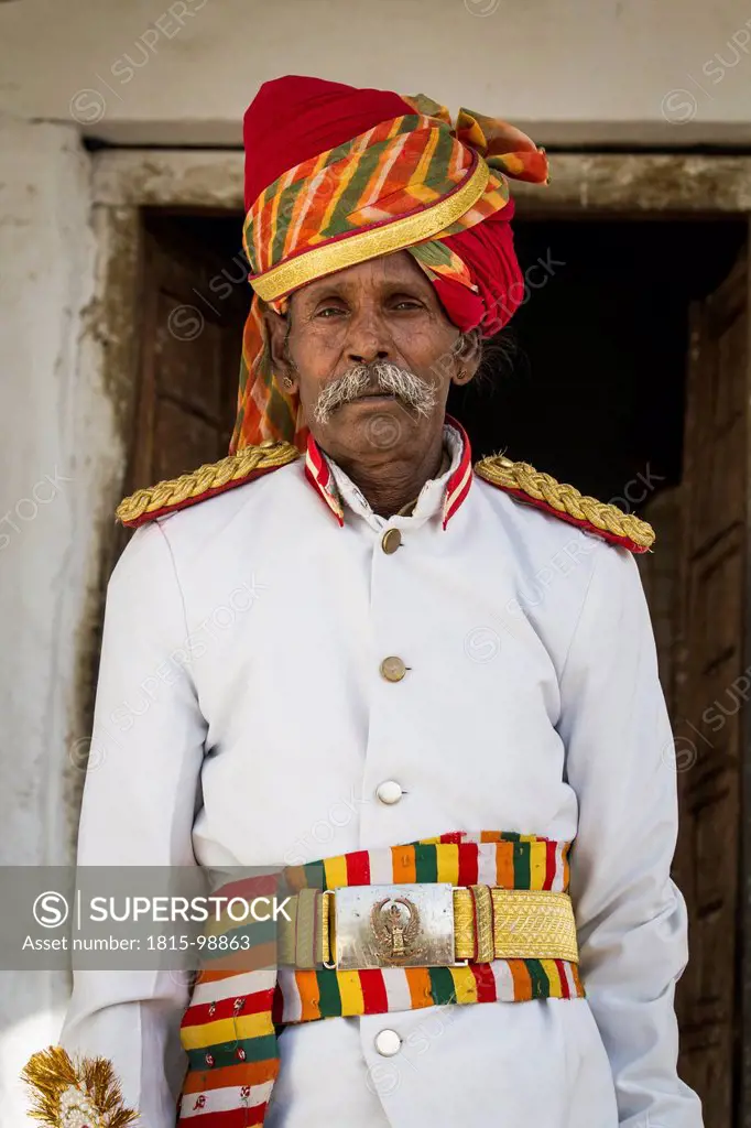 India, Rajasthan, Jodhpur, Portrait of Indian musican in traditional uniform