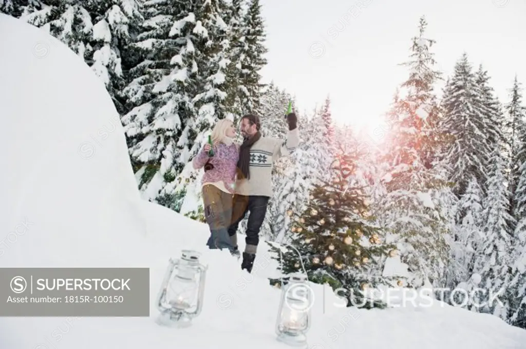 Austria, Salzburg County, Couple celebrating christmas in snowy landscape