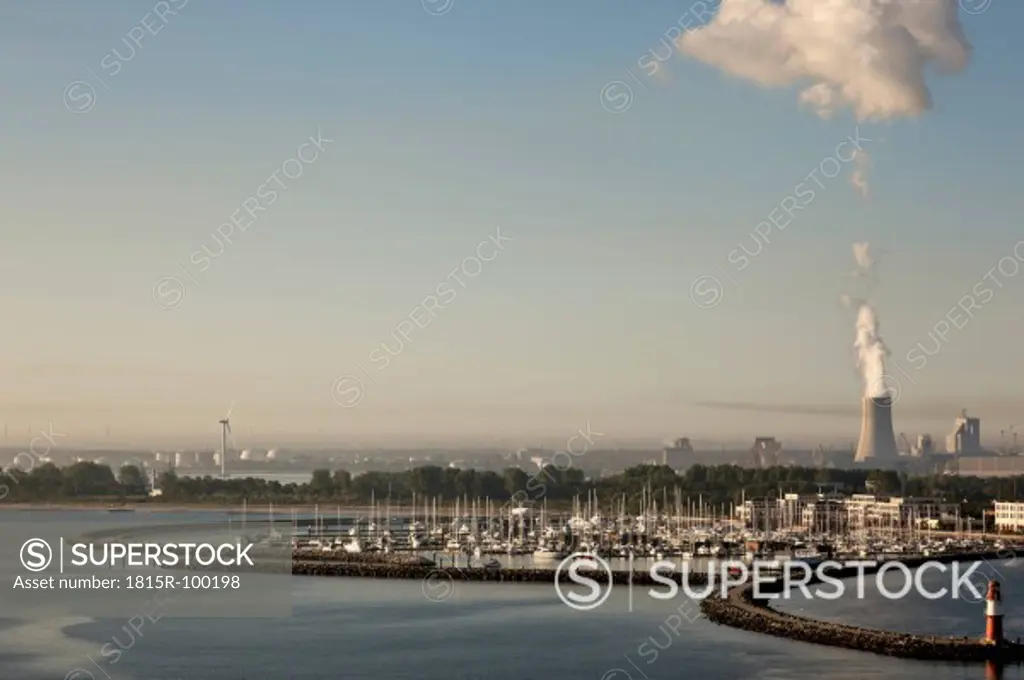 Germany, Rostock, View of harbour and power plant in background