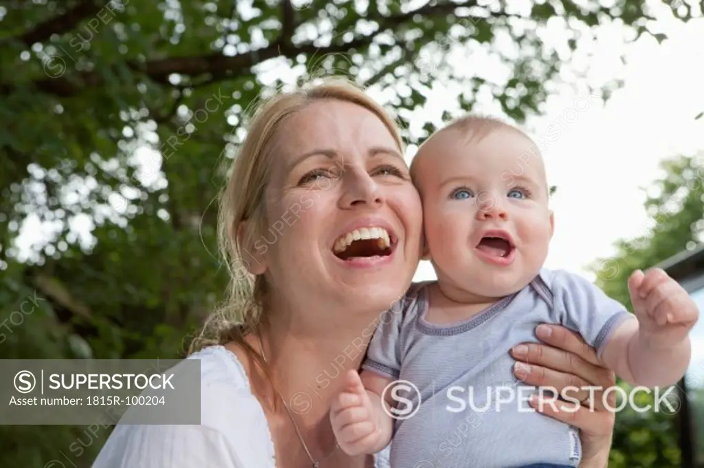Germany, Bavaria, Munich, Mother and baby boy in garden, smiling