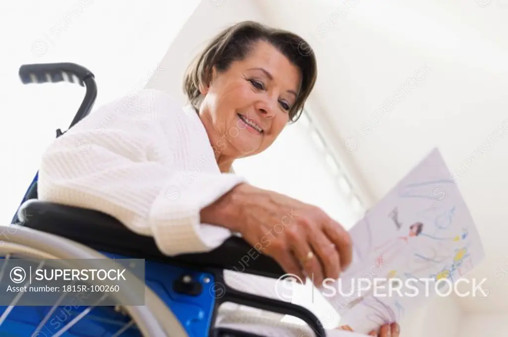 Germany, Leipzig, Senior woman sitting on wheelchair