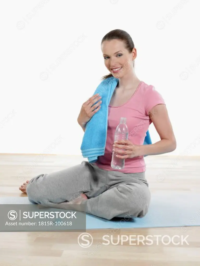 Young woman relaxing after yoga, smiling