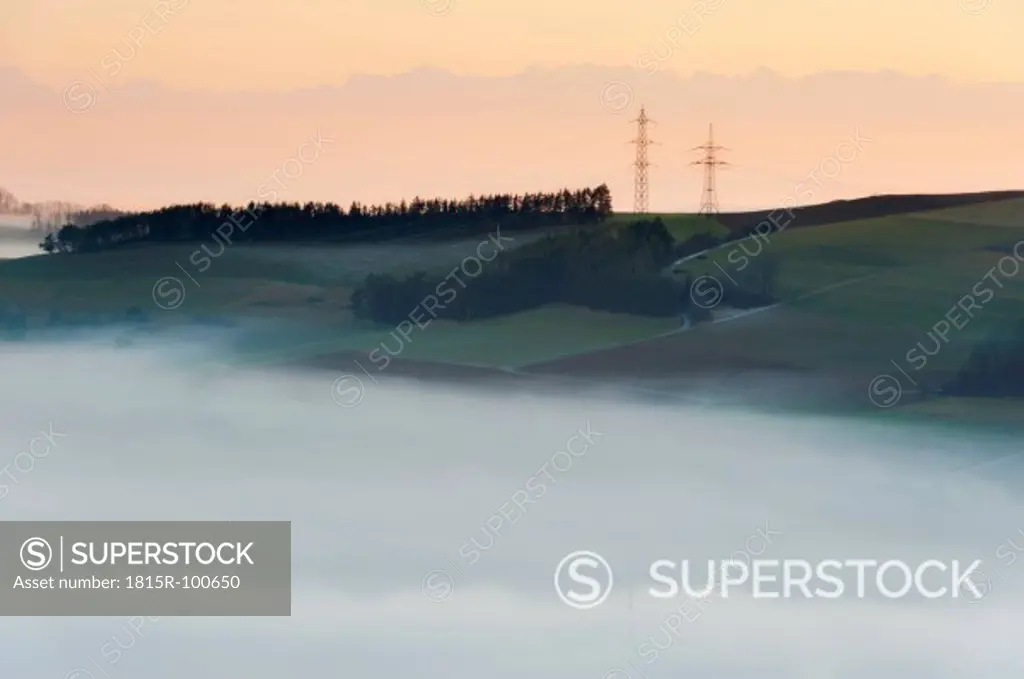 Germany, View of foggy landscape with pylon and Swiss Alps in background