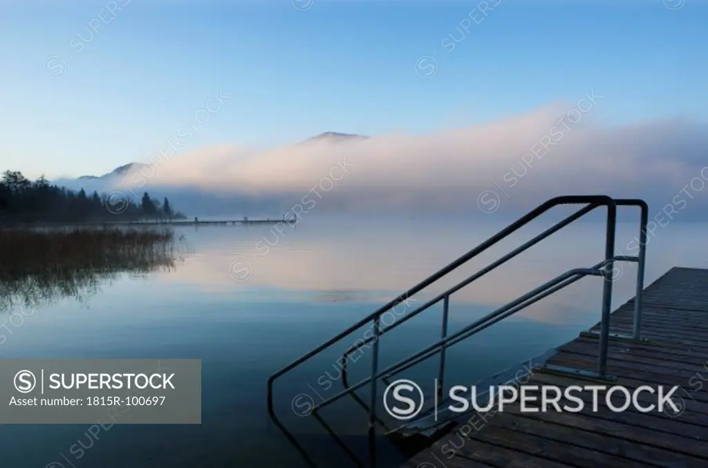 Austria, View of foggy Mondsee Lake during autumn