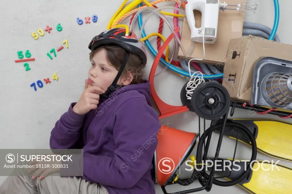 Boy with gadgets and calculating