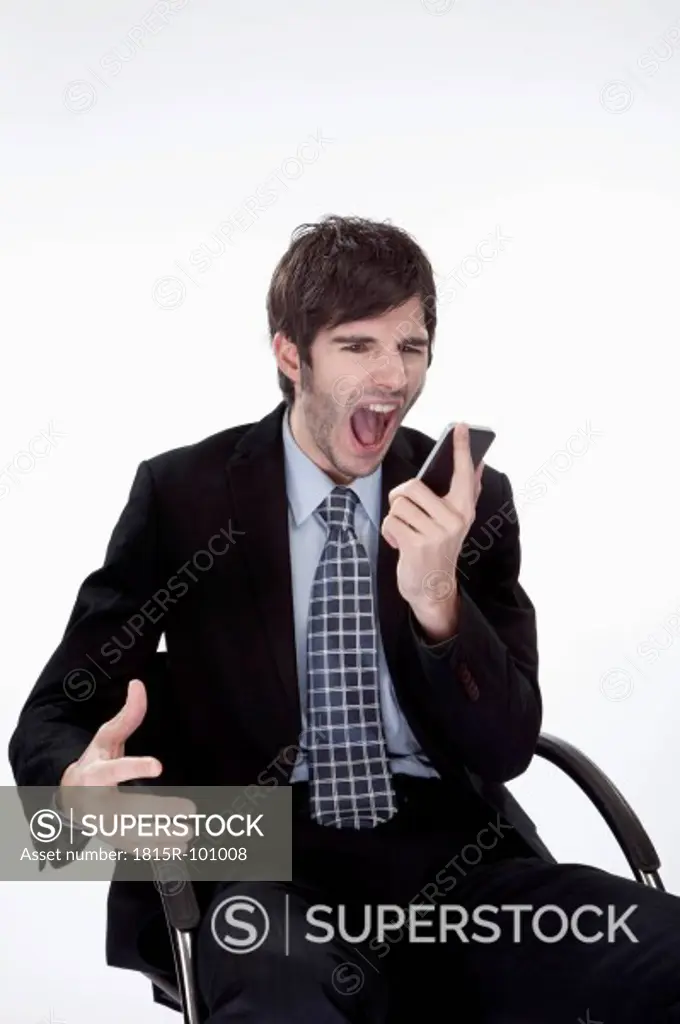 Businessman shouting in mobile phone