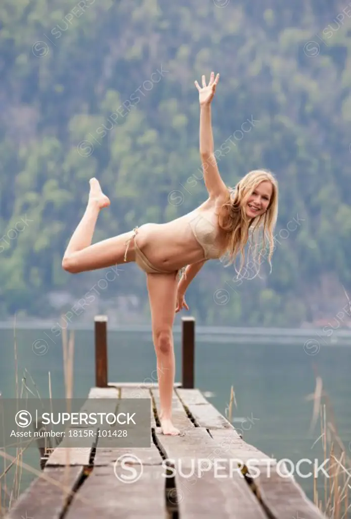 Austria, Teenage girl standing on jetty, portrait