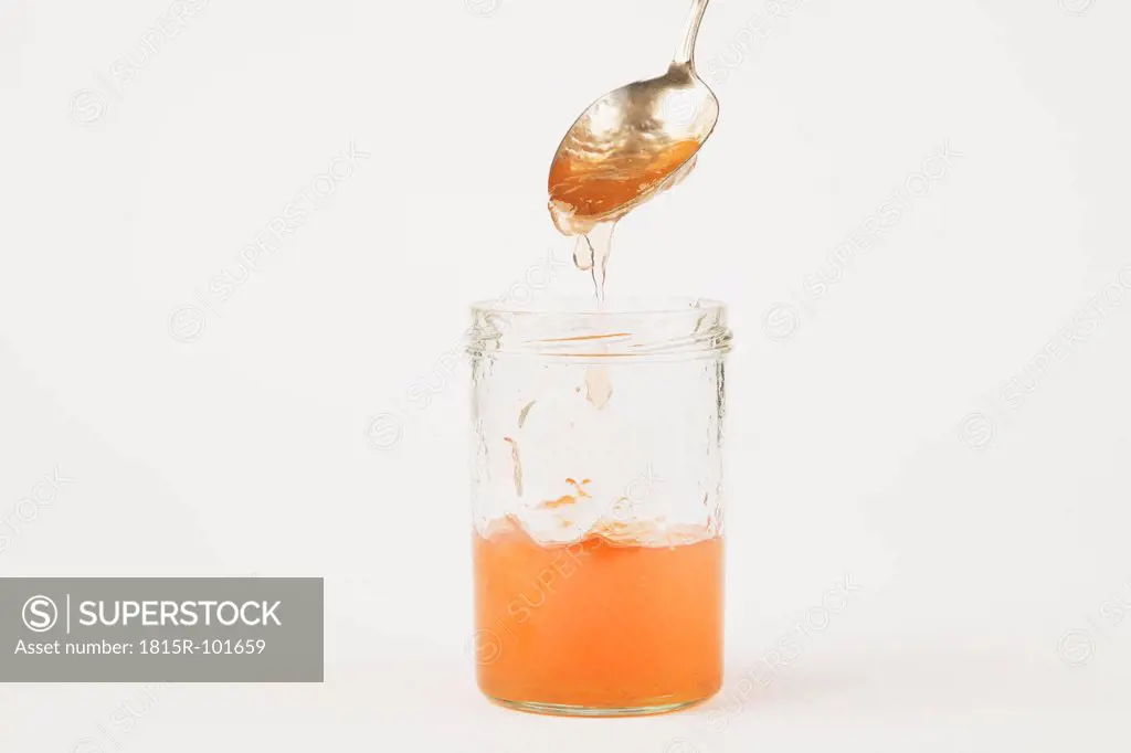 Quince jam in jar on white background