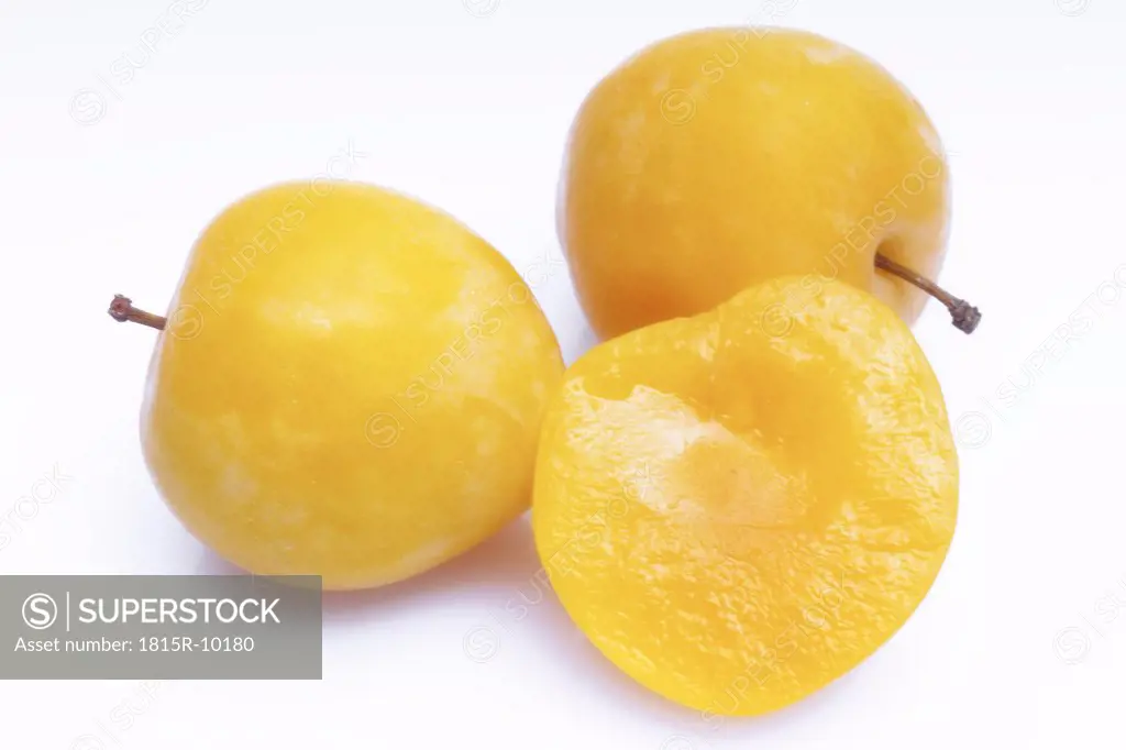 three yellow plums, cut-out, white background