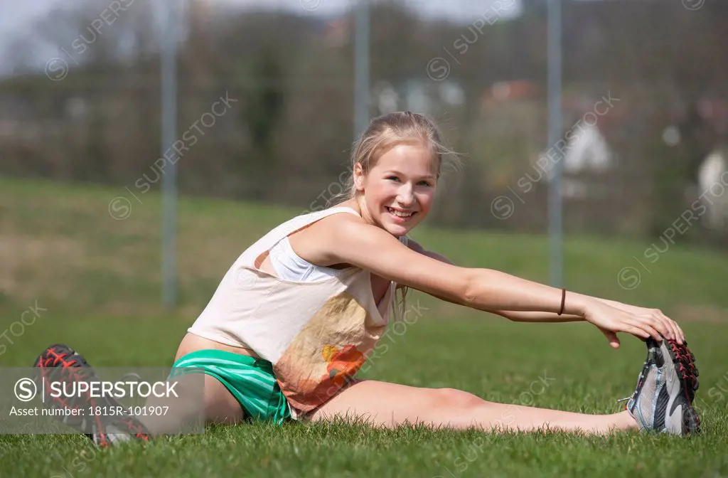 Austria, Teenage girl doing gymnastics, smiling, portrait