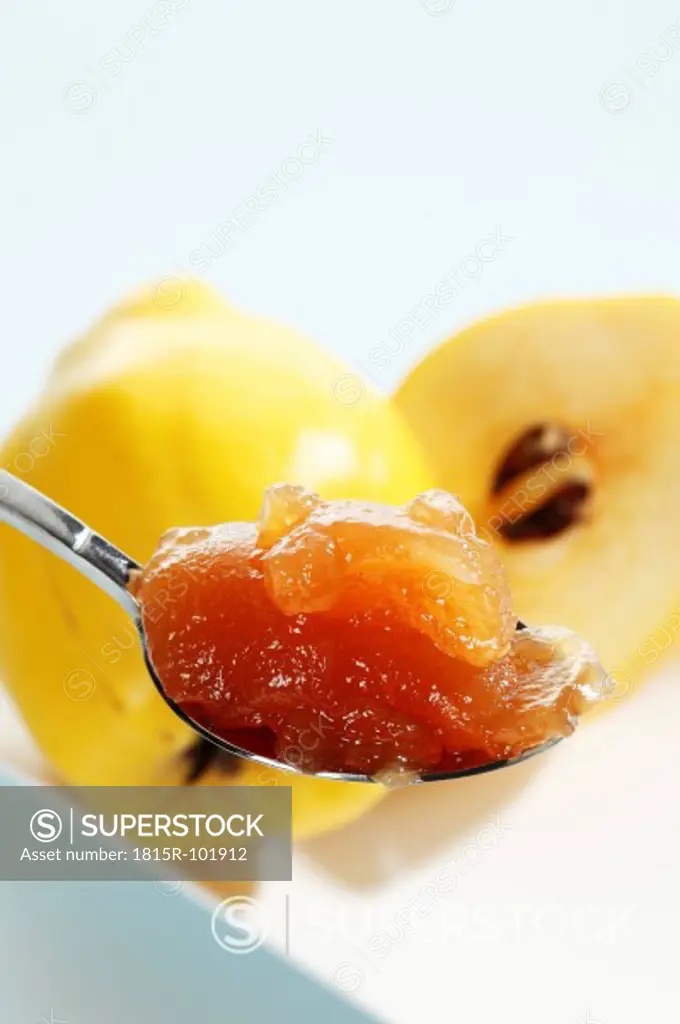 Quinces with jam in spoon, close up