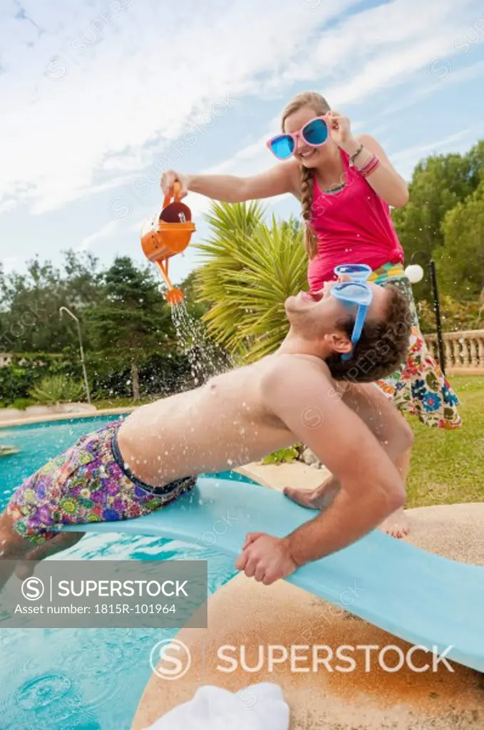 Spain, Mallorca, Couple playing on swimming pool