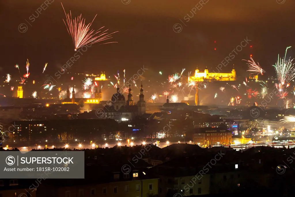 Germany, Bavaria, Wuerzburg, Firework display over cityscape