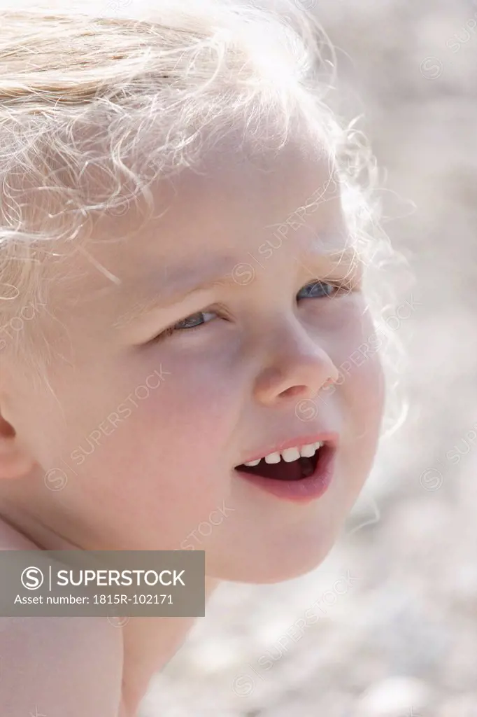 Germany, Bavaria, Girl looking away, smiling, close up