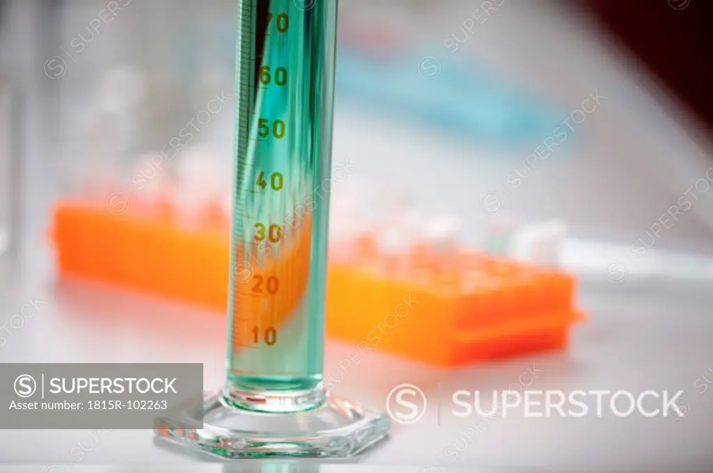 Germany, Bavaria, Munich, Measuring cylinder with green liquid for medical research