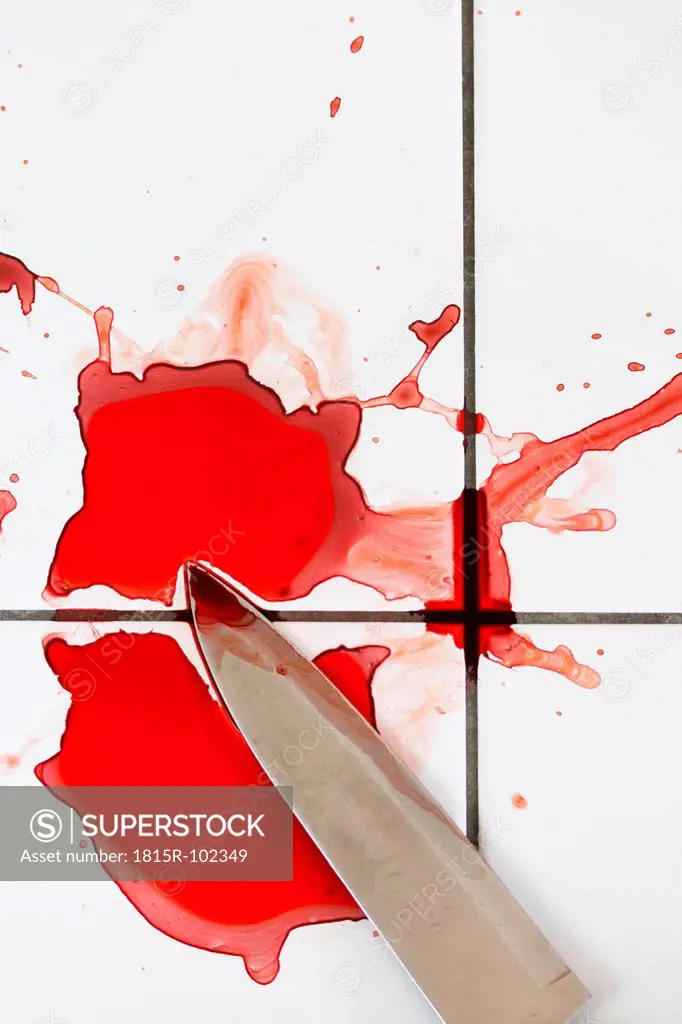 Blood and knife on tiled floor