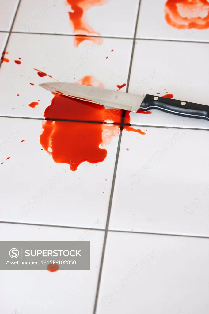 Blood and knife on tiled floor