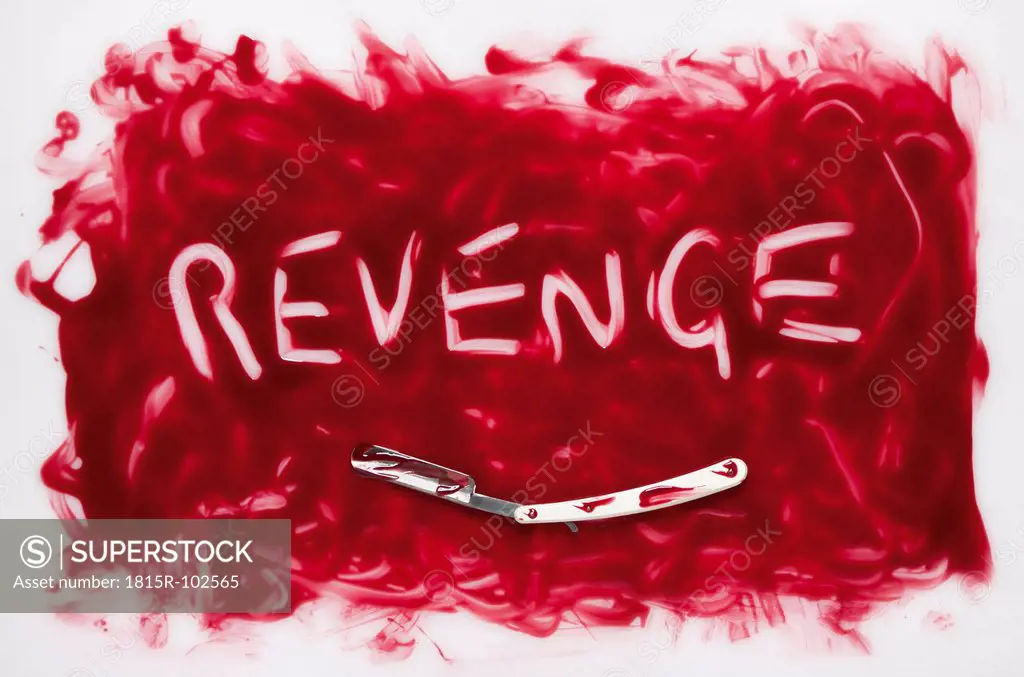 Revenge text written in blood with razor on white background
