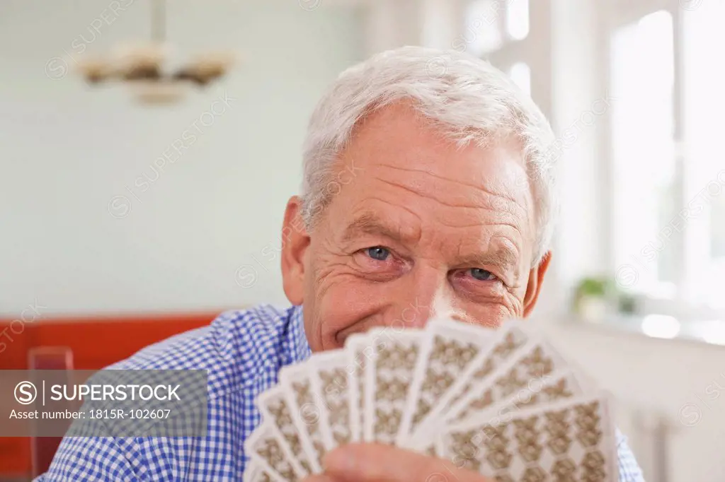 Germany, Leipzig, Senior man playing cards