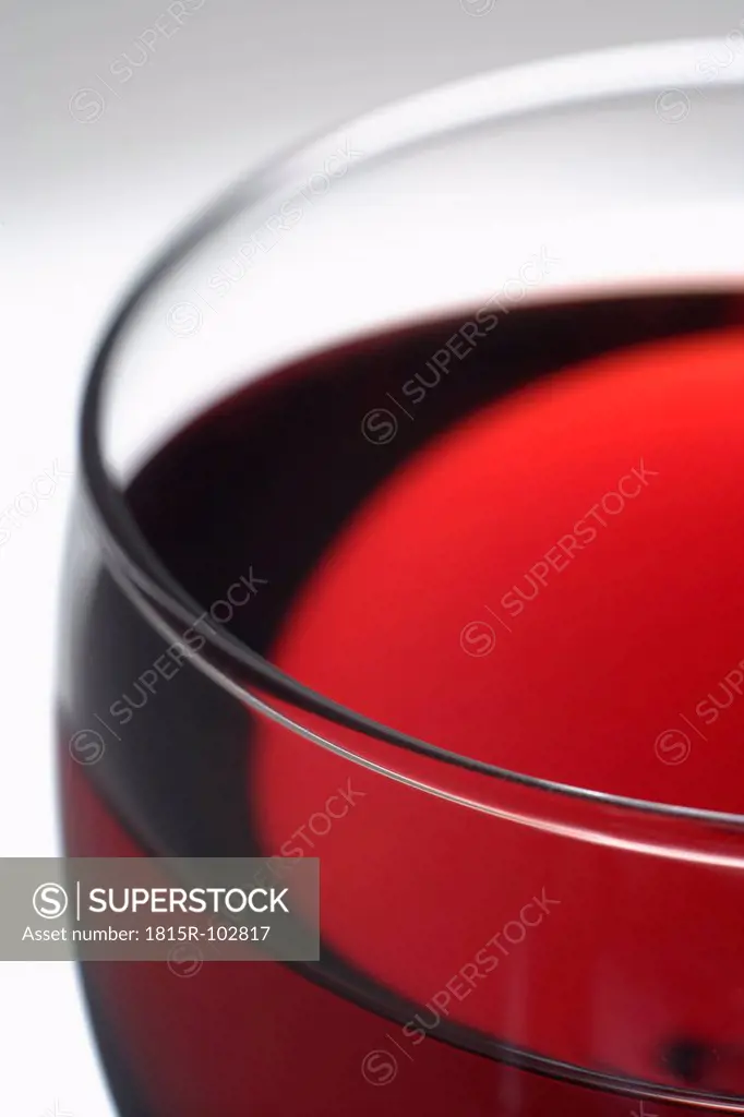 Glass of red wine against grey background