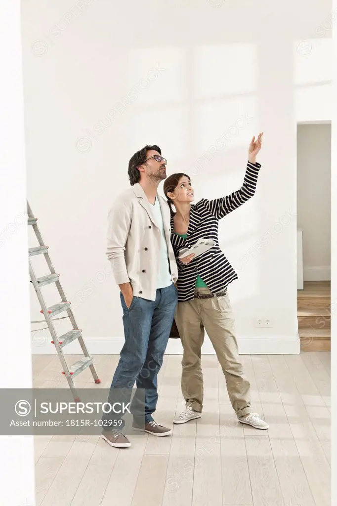 Germany, Berlin, Mature couple inspecting new house