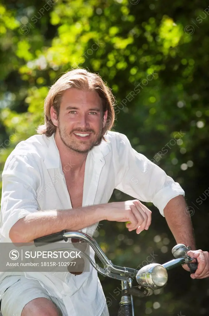 Austria, Salzburg County, Mid adult man riding old bicycle