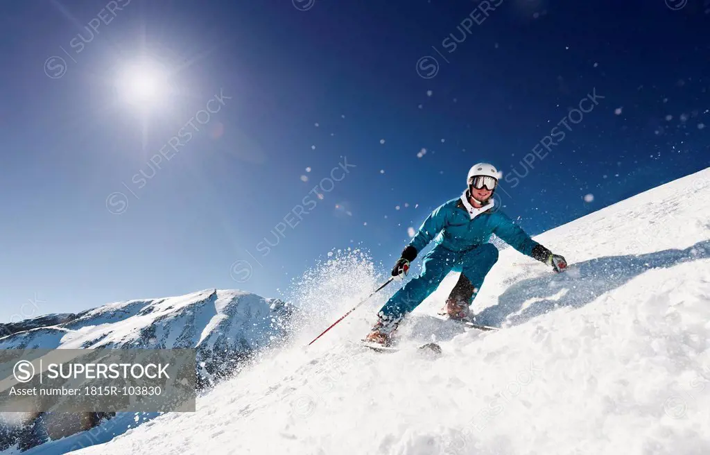 Austria, Salzburg, Young man skiing on mountain