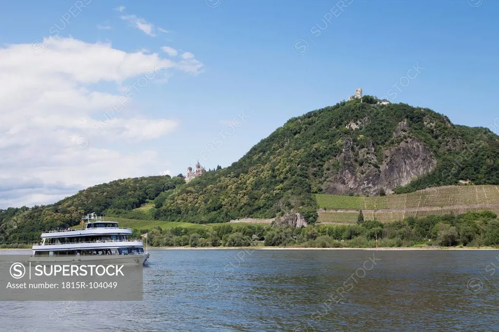 Europe, Germany, North Rhine Westphalia, View of tourboat in Rhine River and castle in background
