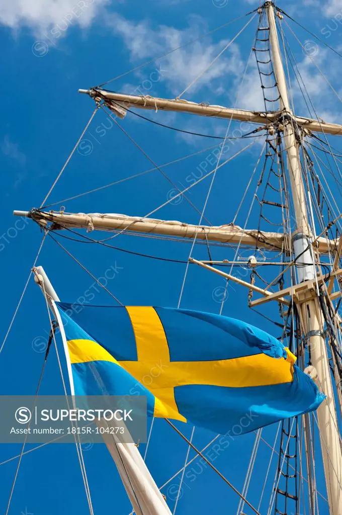 Sweden, Simrishamn, Swedish flag on old sailing boat