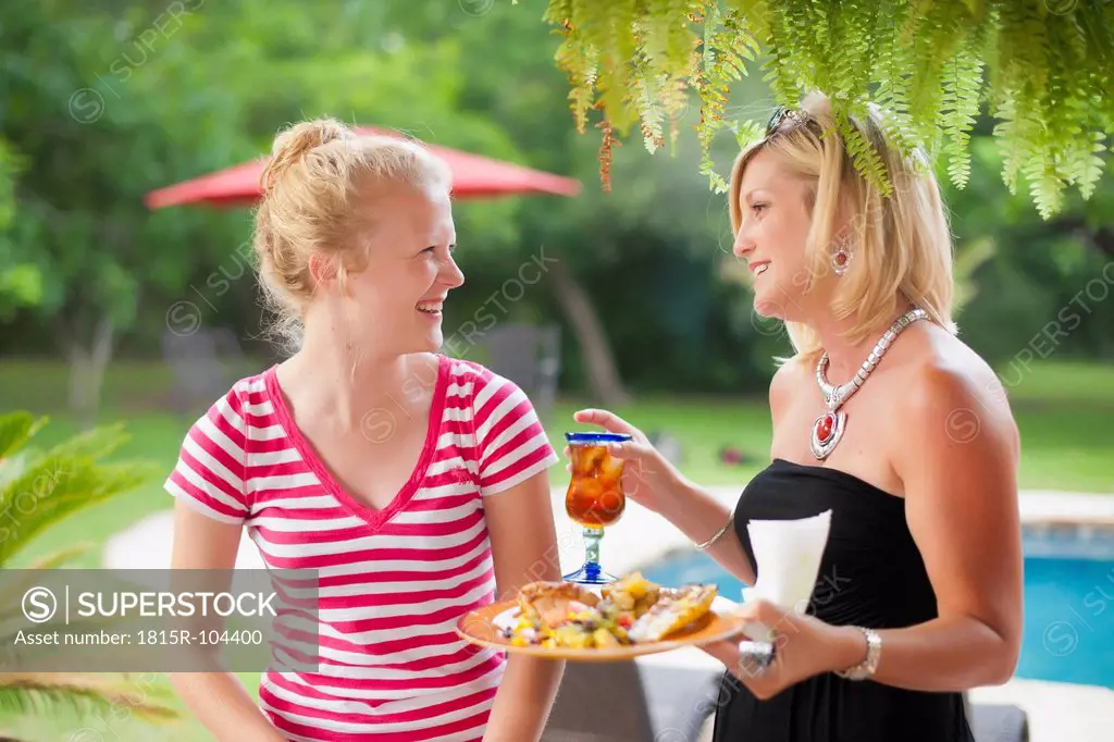 USA, Texas, Mature woman and teenage girl looking at each other, smiling