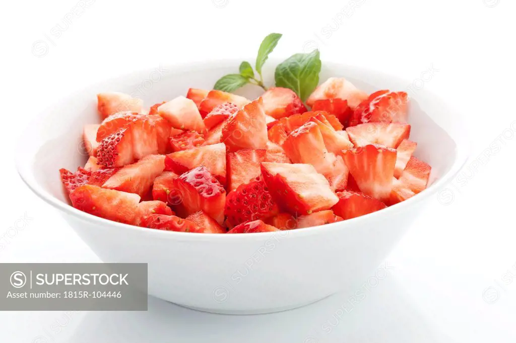 Strawberries in bowl on white background