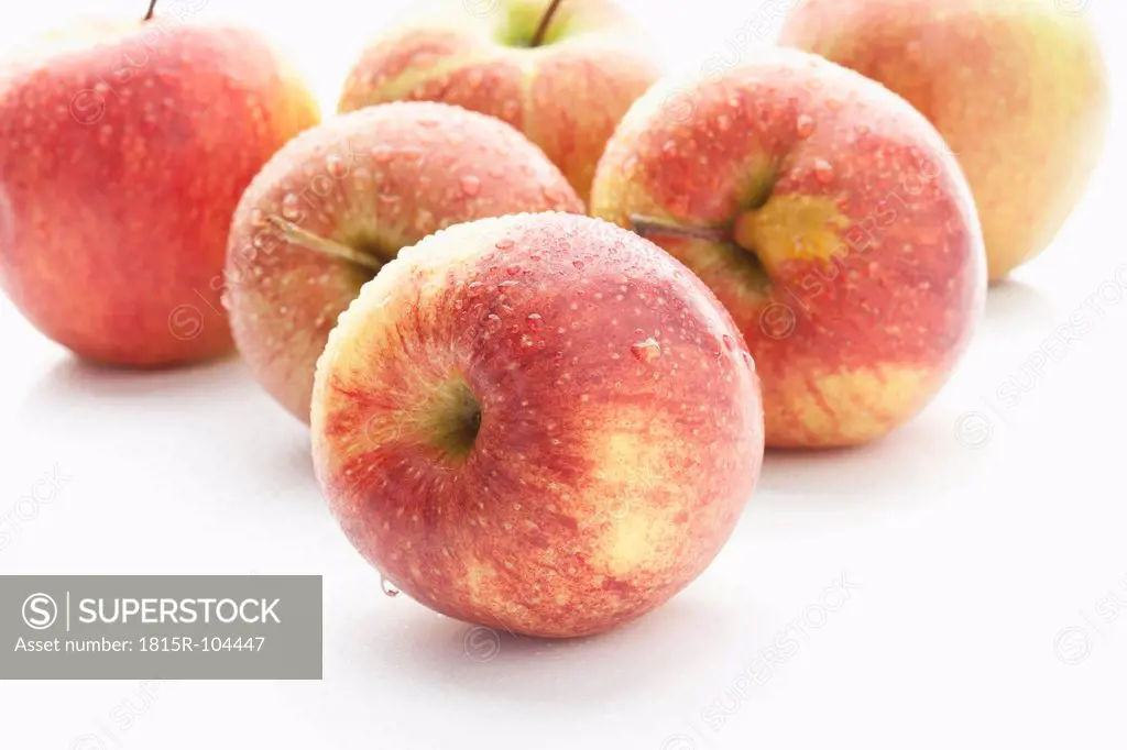 Wet red apples on white background