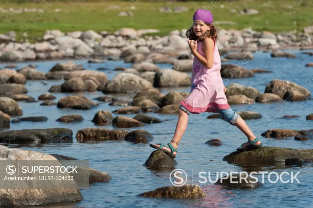 Sweden, Molle, Girl balancing on rock in water