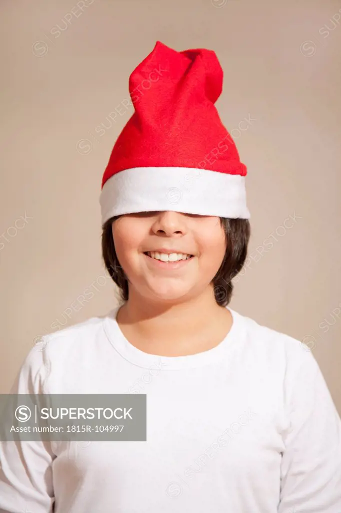 Boy wearing santa hat, smiling