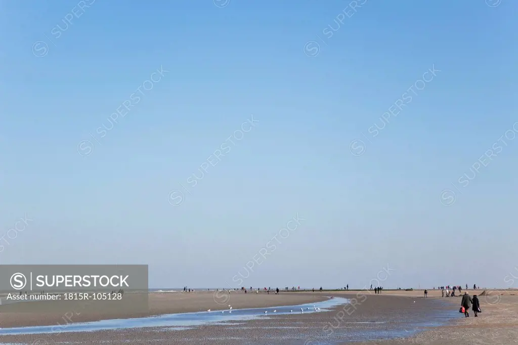 Belgium, Flanders, People walking on beach