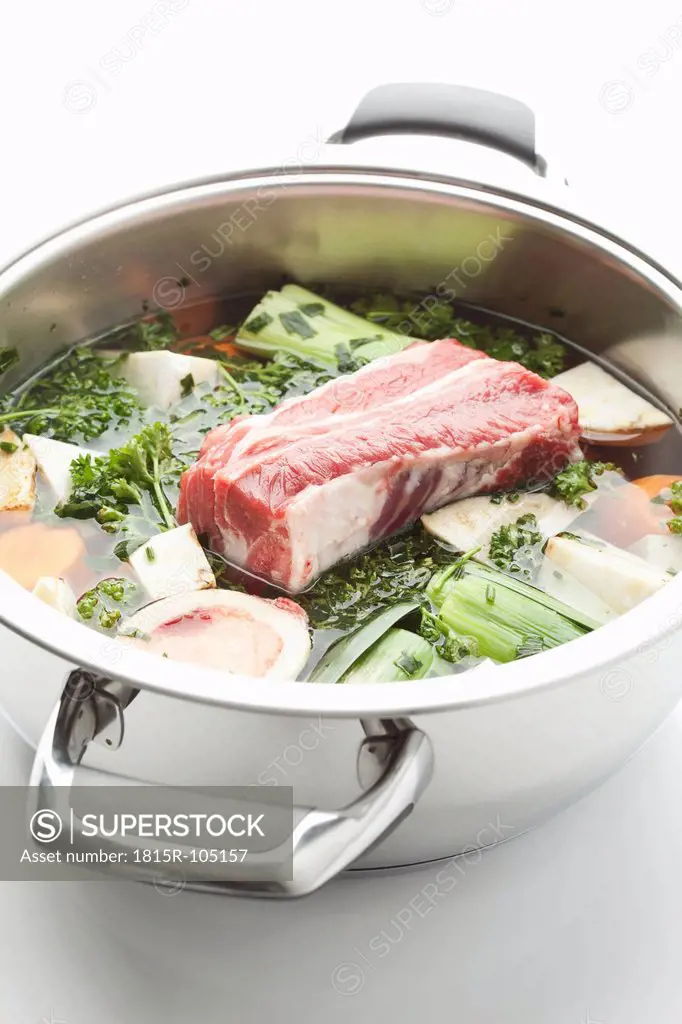 Beef broth ingredient in stew pot on white background